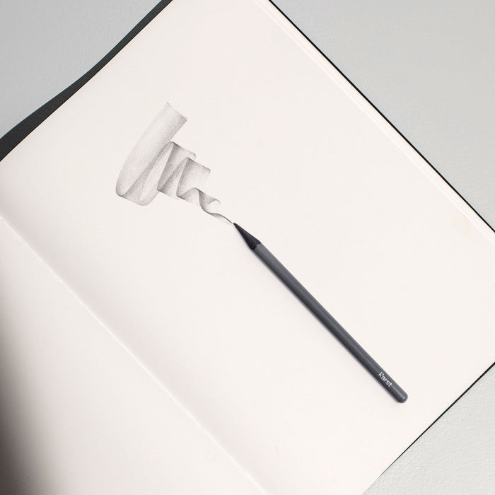 Karst woodless graphite pencil sketching smooth shading on stone paper notebook, premium solid graphite drawing pencil for shading, sketching, and artist illustration.