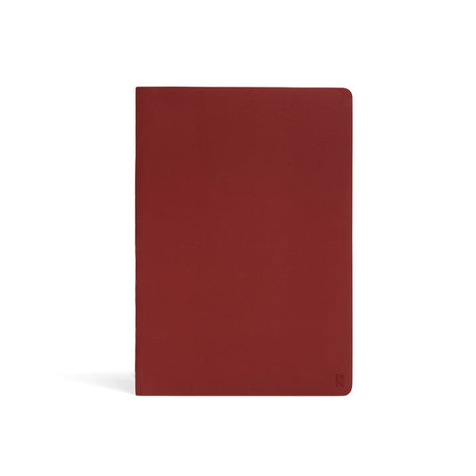 Karst Stone Paper Notebook A5 in burgundy (Pinot), featuring a minimalist soft-touch cover with rounded corners on a white background.