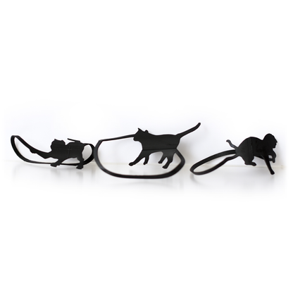 Set of black cat-shaped rubber bands in different playful poses, quirky animal office supplies for organizing papers and adding fun to desk accessories.